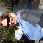 Lindy with Isaac in the carrier on the bridge over Indian River