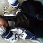 Squirmy Isaac in his suit and sweater