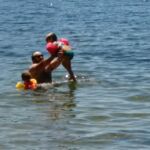 Matt playing with Lyla and Finley in the water