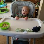 Still so tiny in the high chair