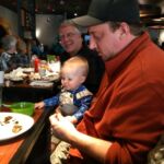 Uncle Greg feeding Isaac at brunch