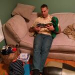 Daddy reading Oscar and Wrinkles a story when Isaac wouldn't sit and listen