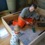 Isaac supervising daddy's work