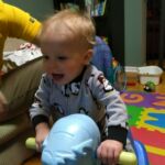 Isaac likes his rocking horse