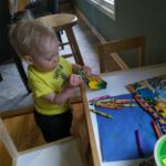 Developing his hand eye coordination and loves putting the crayons back in the box