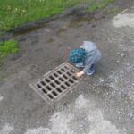 Favourite game - to drop rocks down the storm drain