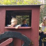 Isaac and Inez and Noelia riding the train