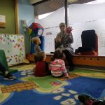 Listening attentively to story time at the toy library playgroup