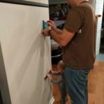 helping daddy mount the TV