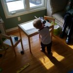 Isaac cleaning up with the vacuum