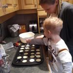 Helping to make the cupcakes to share with his friends at daycare