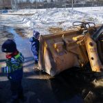 Iden and Isaac exploring the big machines at the park