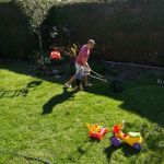 Helping to cut the lawn