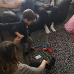 Zavier, Matt and Andrea watching Arlo play with his new rocket