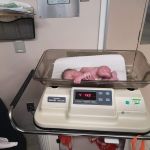 Asher trying to climb off the weigh scale