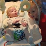 Isaac playing kick the ball with Asher