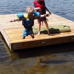 Isaac and Iden jumping off the raft