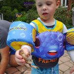 Isaac found a frog in Glenna's pool