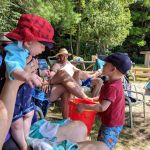 showing the frog to everyone (it's in the pail)