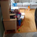 Asher loves the play kitchen