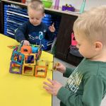 Gale and Isaac building a garage for their truck
