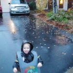Isaac trick or treating in the rain