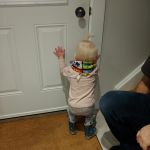 Cadence put the neck warmer on herself, getting ready to go outside