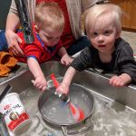 helping to do the dishes